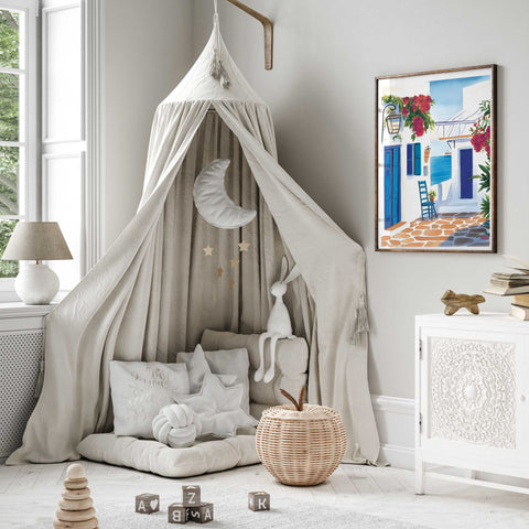 Blue and white coastal architecture with stone tiles and a chair

