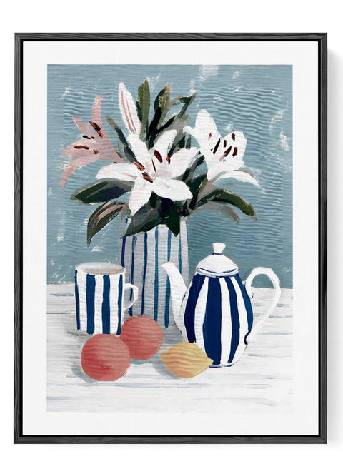 Contemporary kitchen wall decor with fresh oranges and a ceramic teapot.