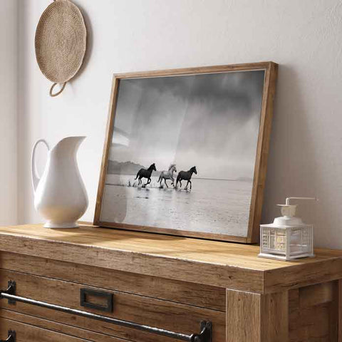 Dramatic horse splashing water art print with vast sky and mountain silhouettes