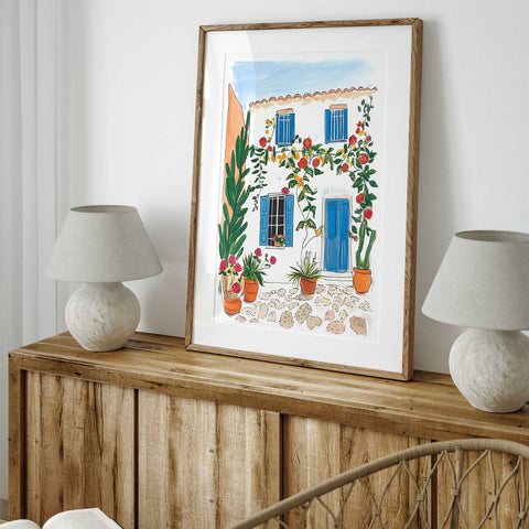 Hand-painted Mediterranean home with potted cacti and climbing plants

