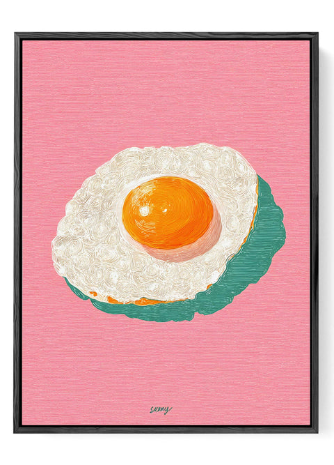Modern kitchen wall decor featuring a simple fried egg illustration.