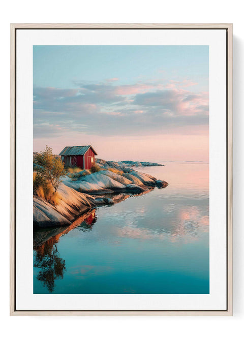 Nordic sunset landscape print featuring red cabin on rocky shore with calm reflection
