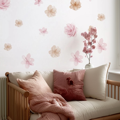 Decorative floral wall stickers on a wall with a sofa and pillows in a room.