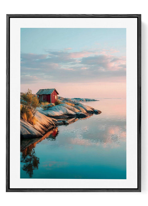 Serene coastal evening print showing red wooden cottage by calm blue water