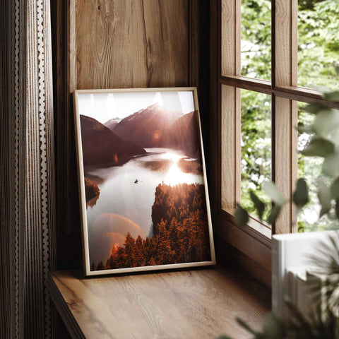 Sun rays reflecting off water in a mountain valley landscape art print.